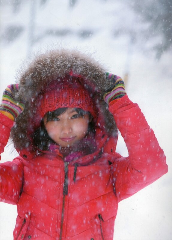 woman in red coat in snow