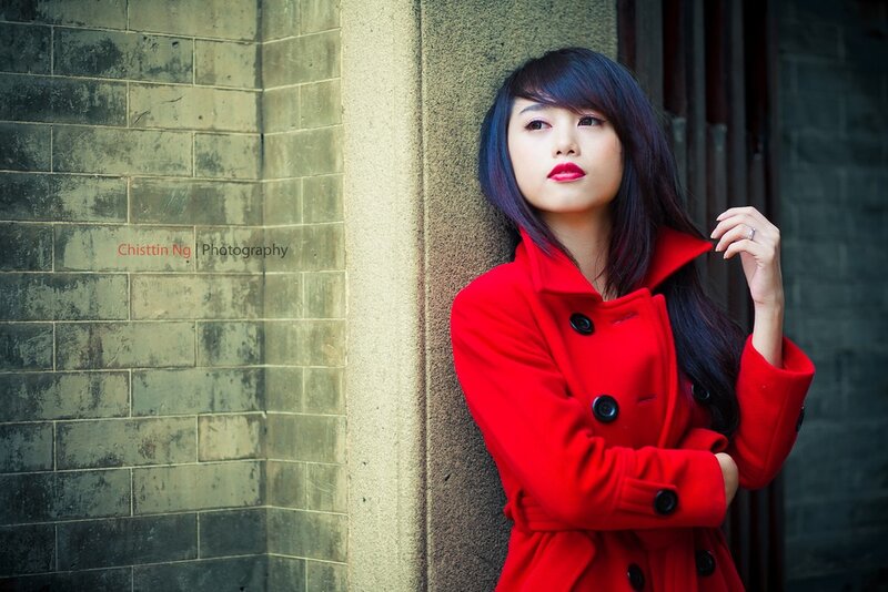 woman in red coat leaning