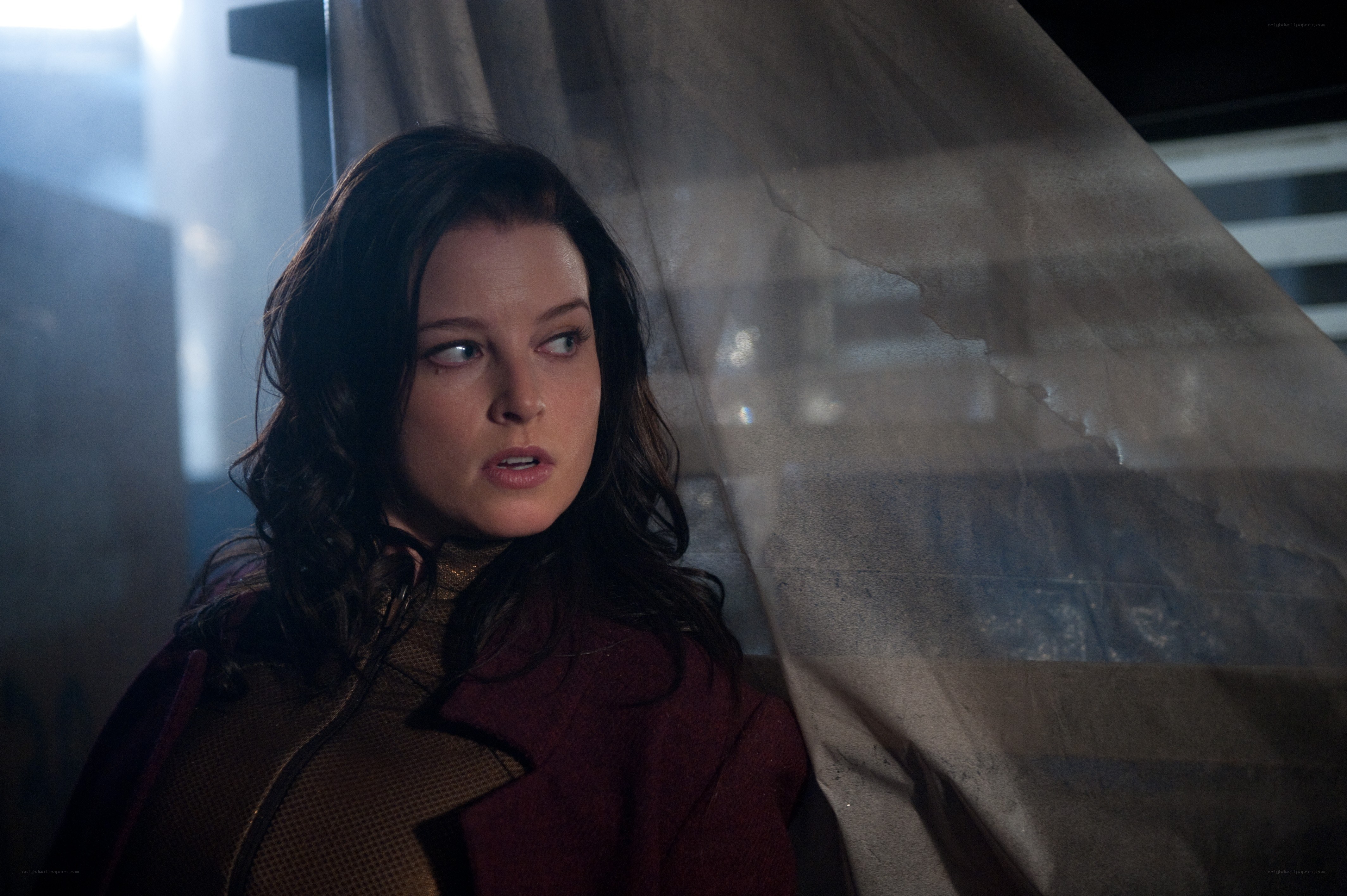 woman in red coat looking scared