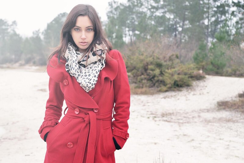 woman in red coat on beach