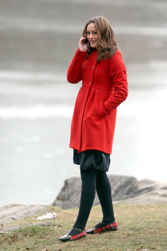 Woman in red coat on phone