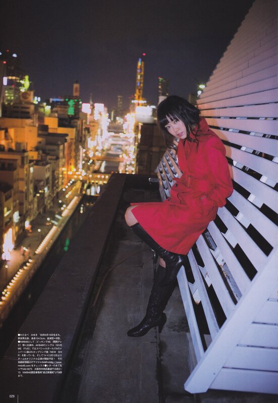 Woman in red coat on rooftop