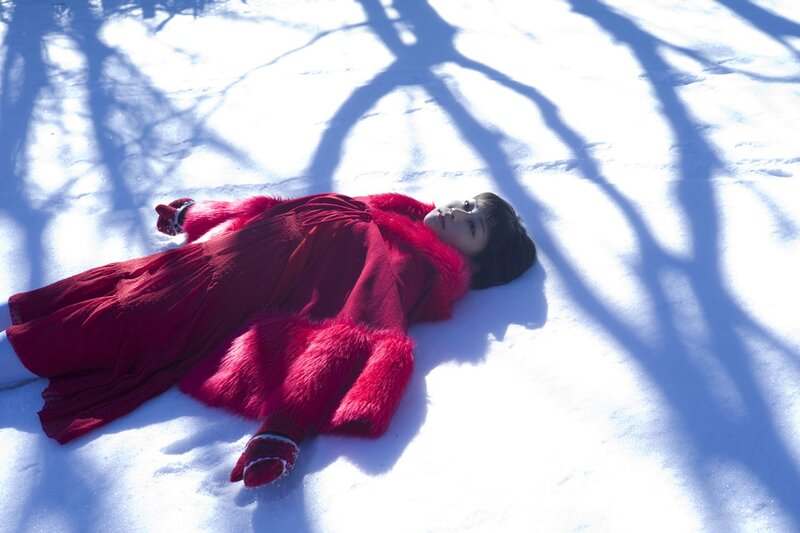 Woman in red coat on snow