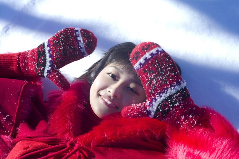 Woman in red coat on snow