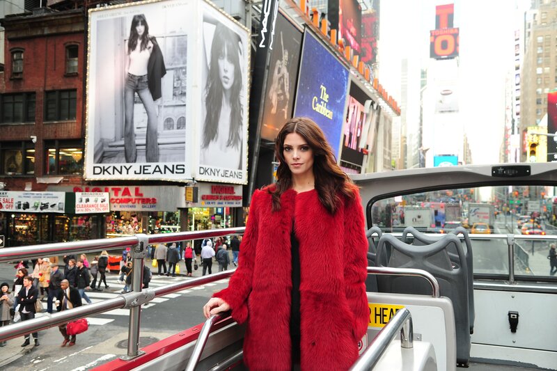 Woman in red coat on tour bus