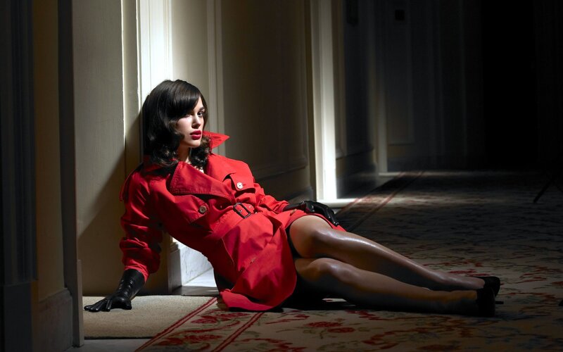 woman in red coat sitting on floor