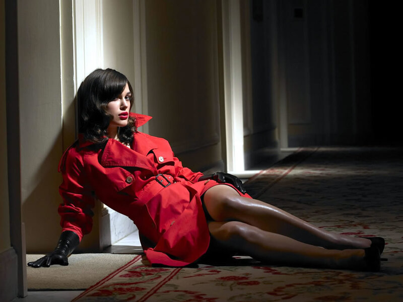 Woman in red coat sitting on floor
