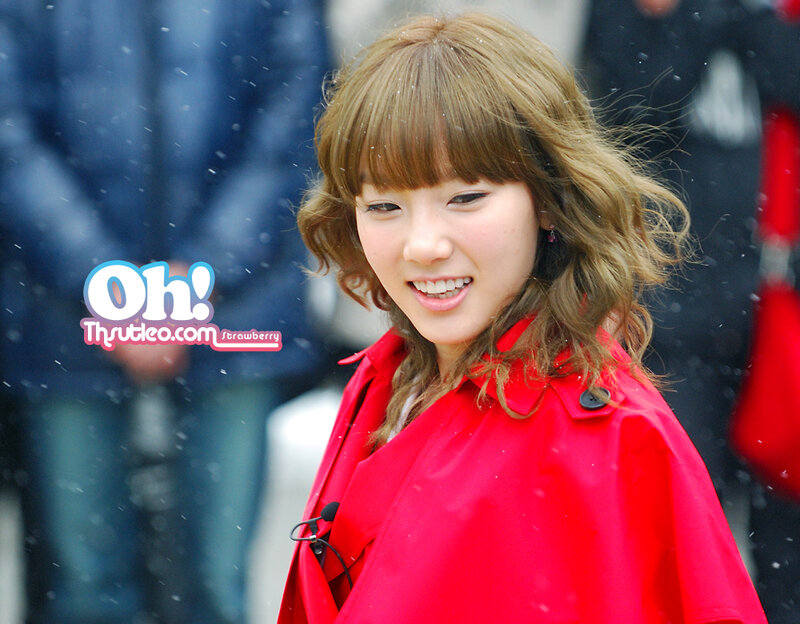 woman in red coat smiling
