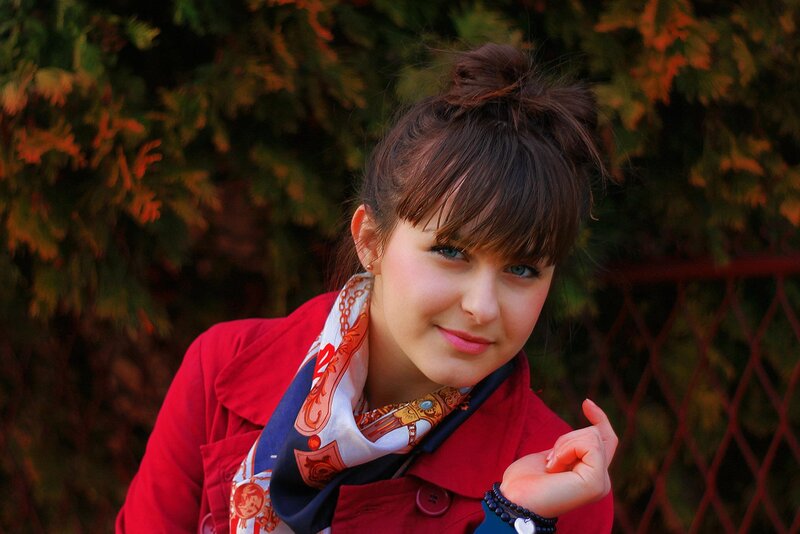 woman in red coat smiling