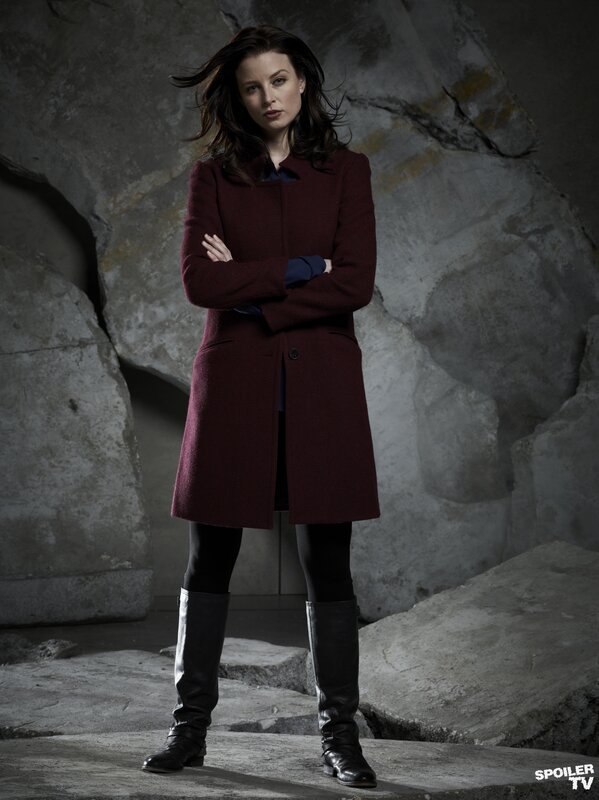 woman in red coat standing