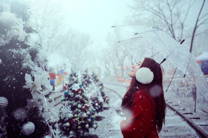 Woman in red coat under snow