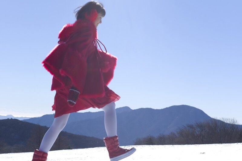 Woman in red coat walking in snow