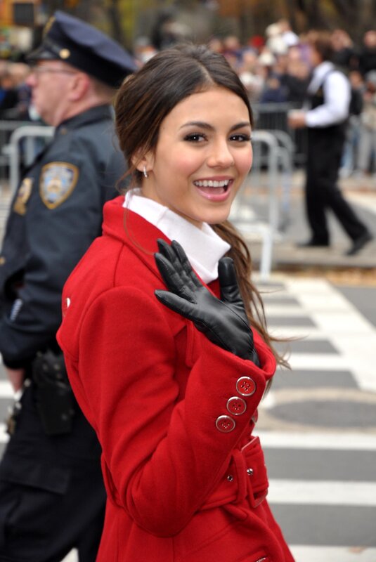 woman in red coat waving