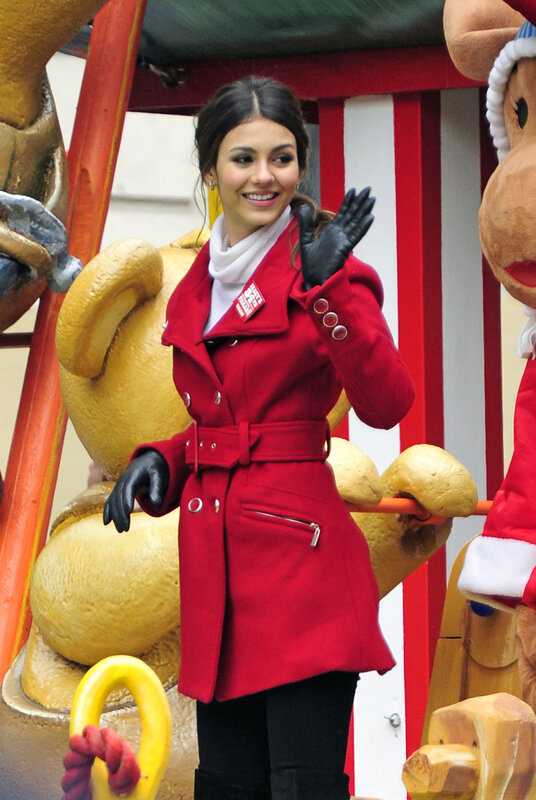 Woman in red coat waving
