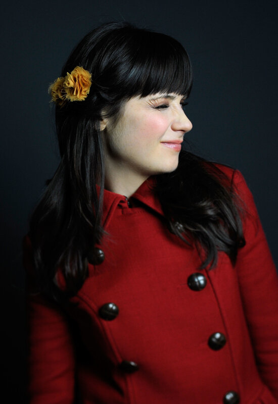 woman in red coat with flower