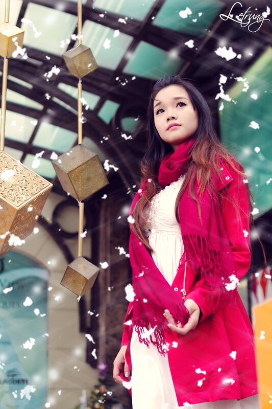 woman in red coat with snow effect