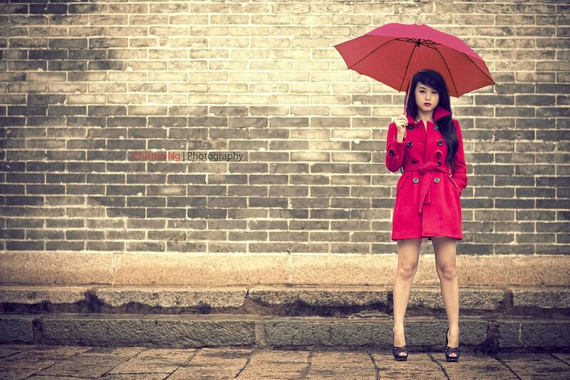Woman in red coat with umbrella