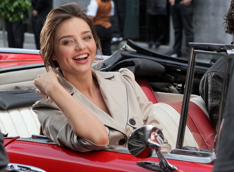 woman in red convertible car