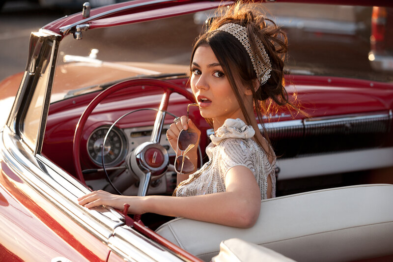 woman in red convertible car