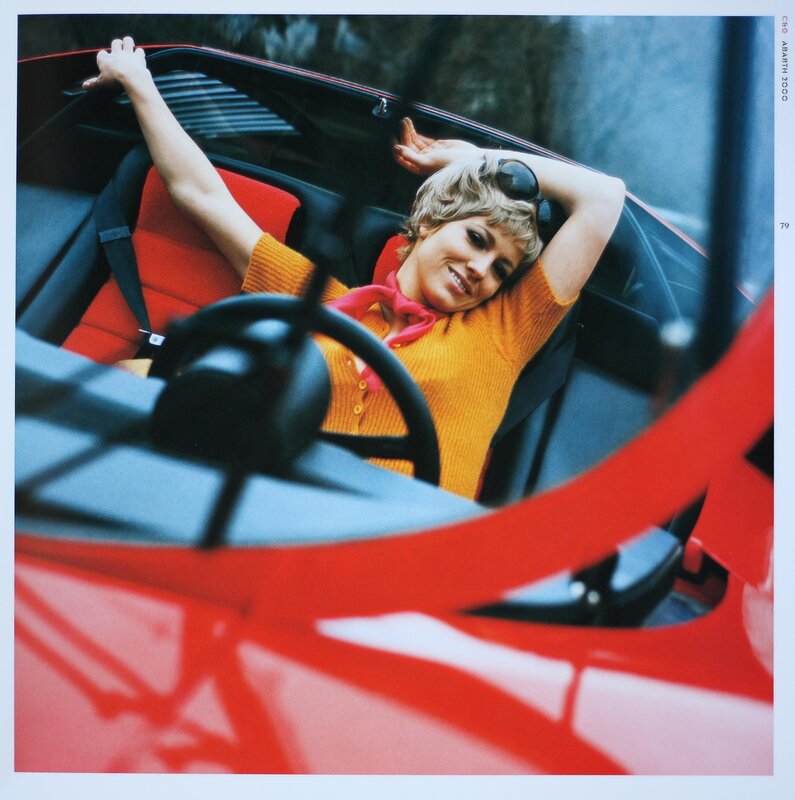 Woman in red convertible car