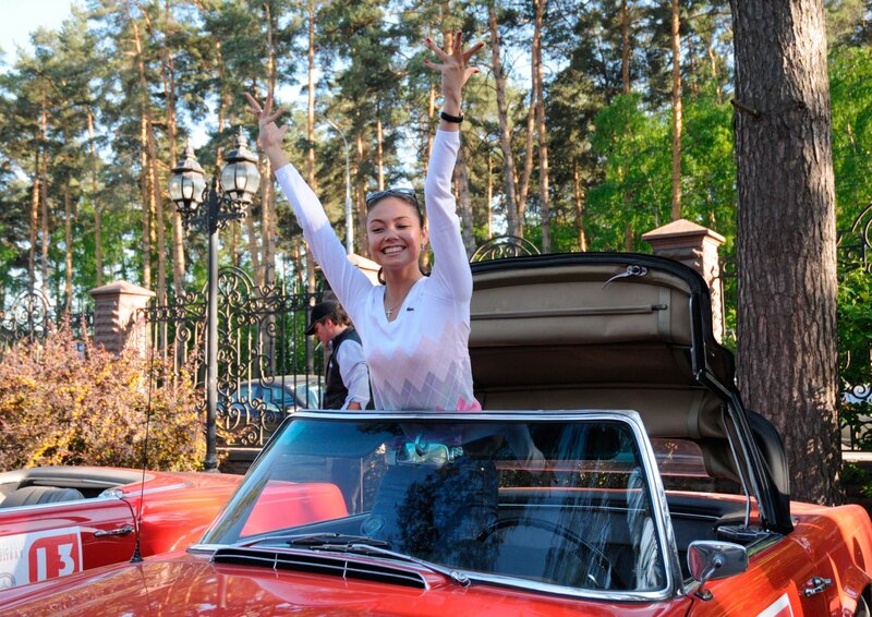 Woman in red convertible car