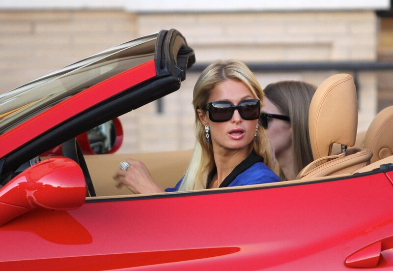 woman in red convertible car