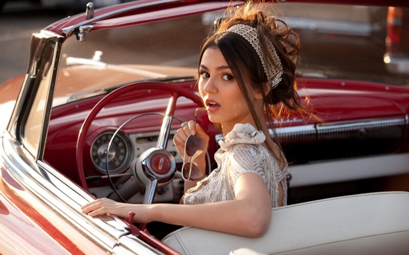 woman in red convertible car