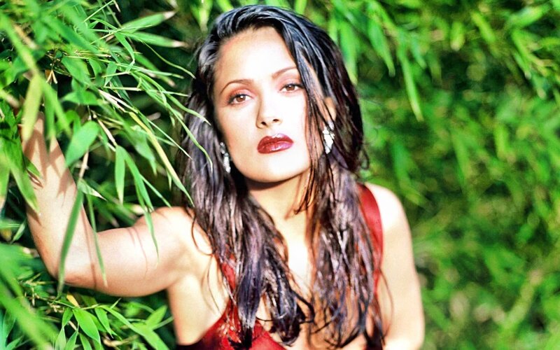 woman in red dress among bamboo