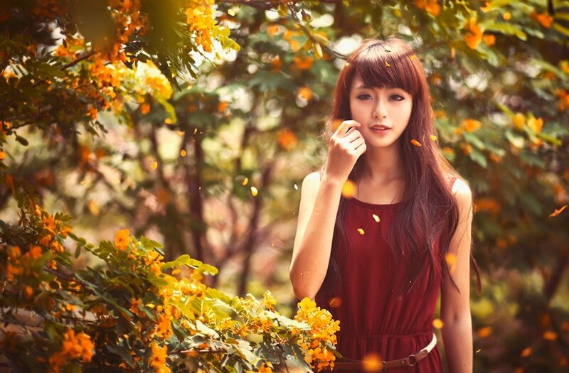 woman in red dress among flowers