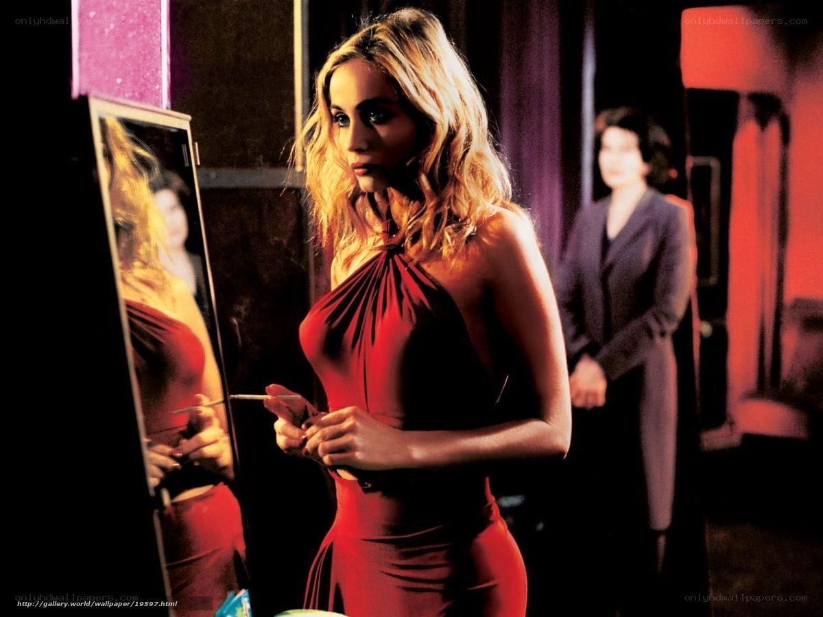 Woman in red dress applying makeup
