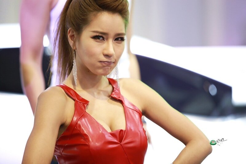 Woman in red dress at auto show