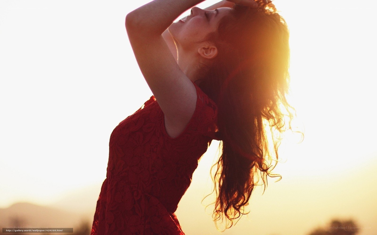 woman in red dress at sunset