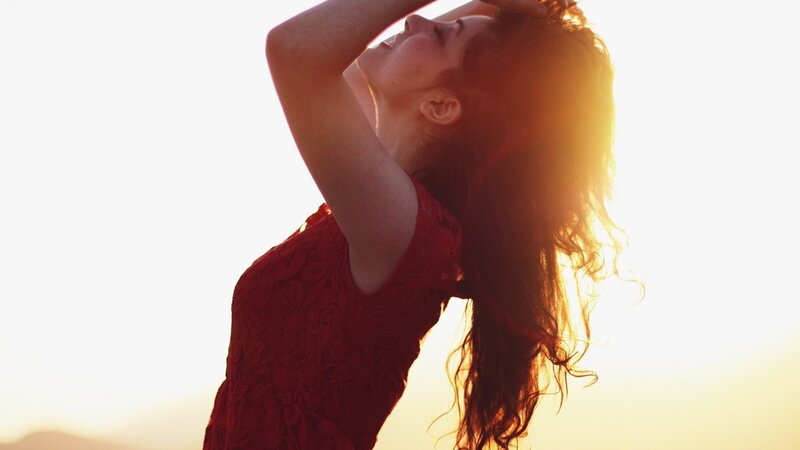 woman in red dress at sunset