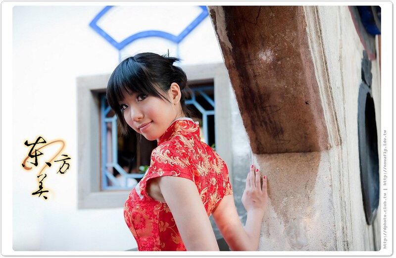 woman in red dress at traditional building