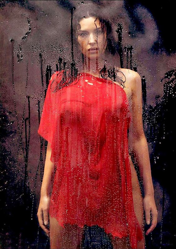 woman in red dress behind glass