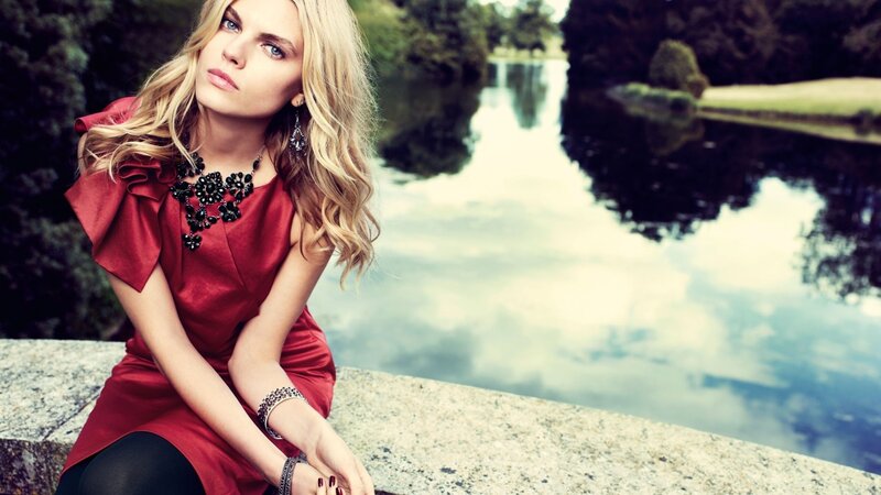woman in red dress by lake