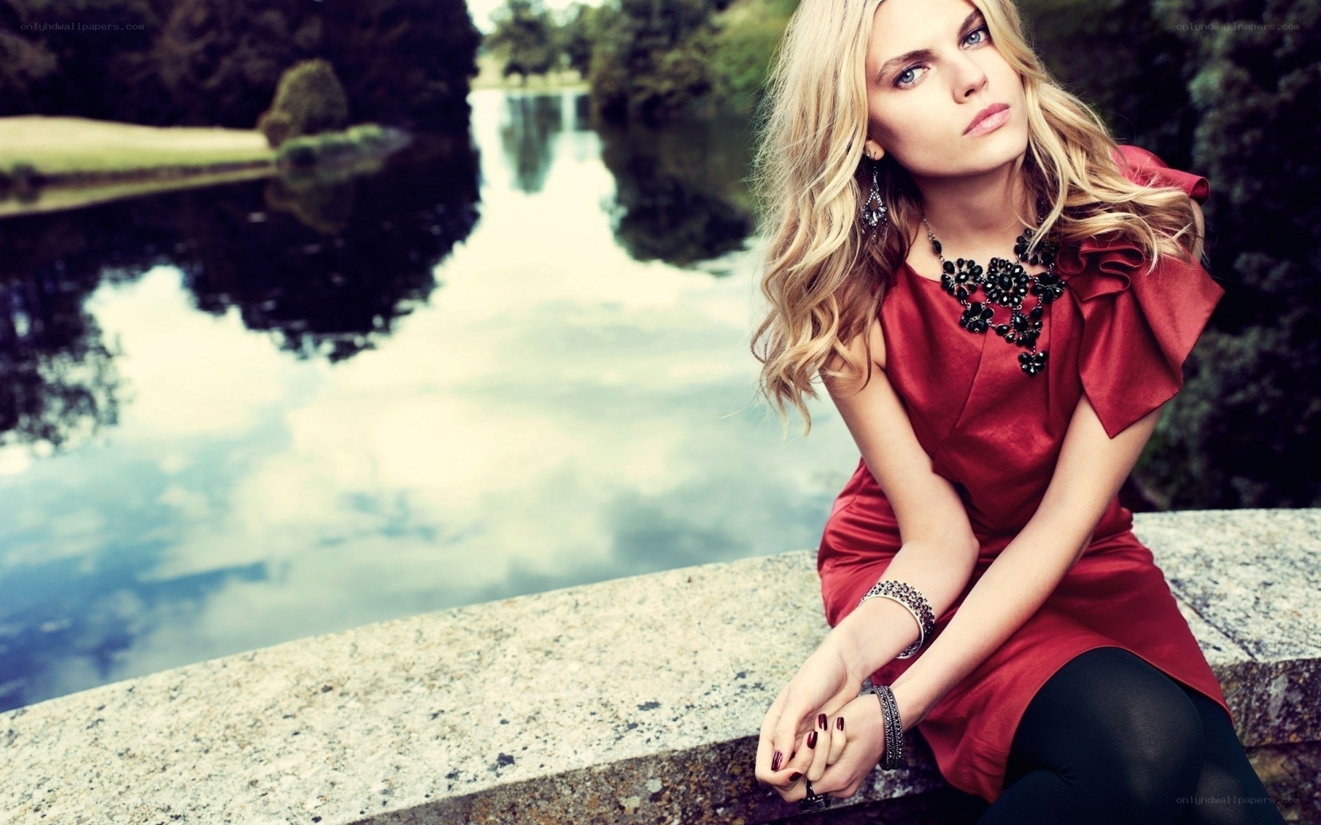 woman in red dress by lake