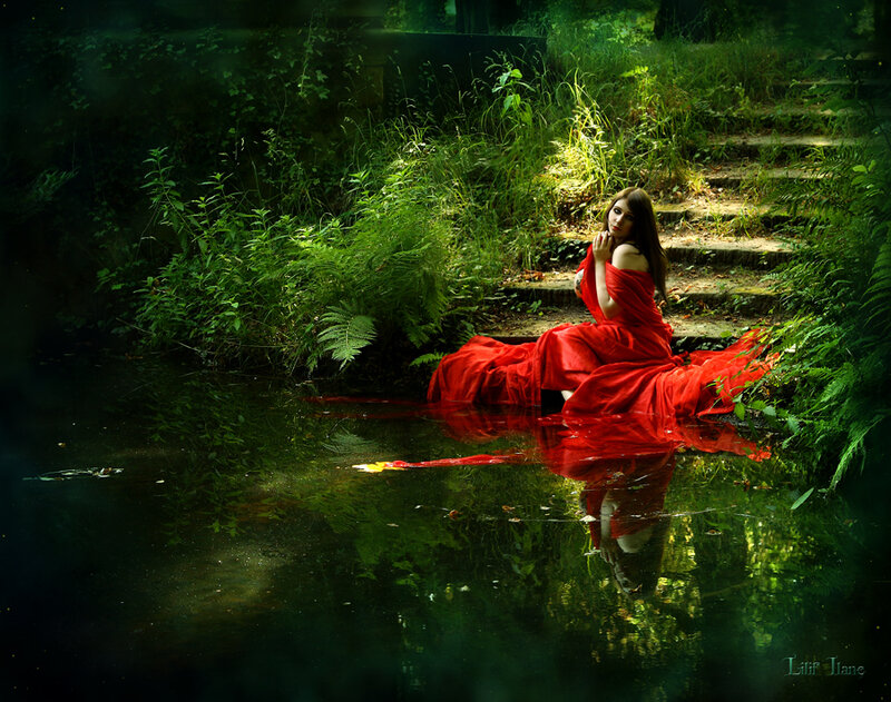 Woman in red dress by pond