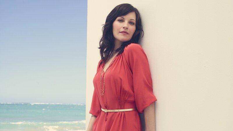 woman in red dress by the sea
