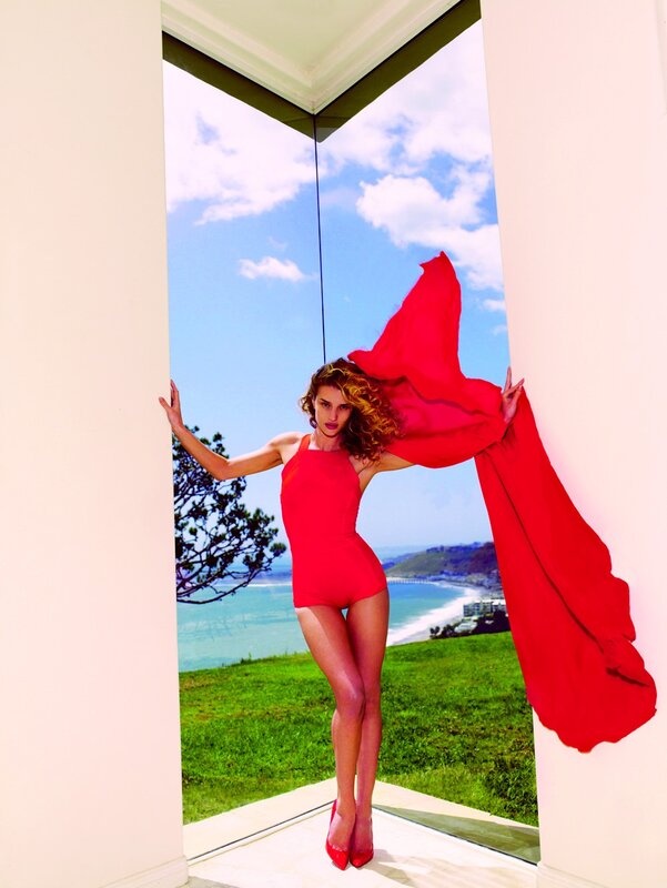 Woman in red dress by the sea