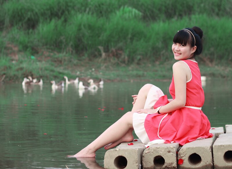 Woman in red dress by the water