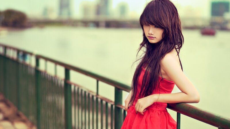 woman in red dress by the water