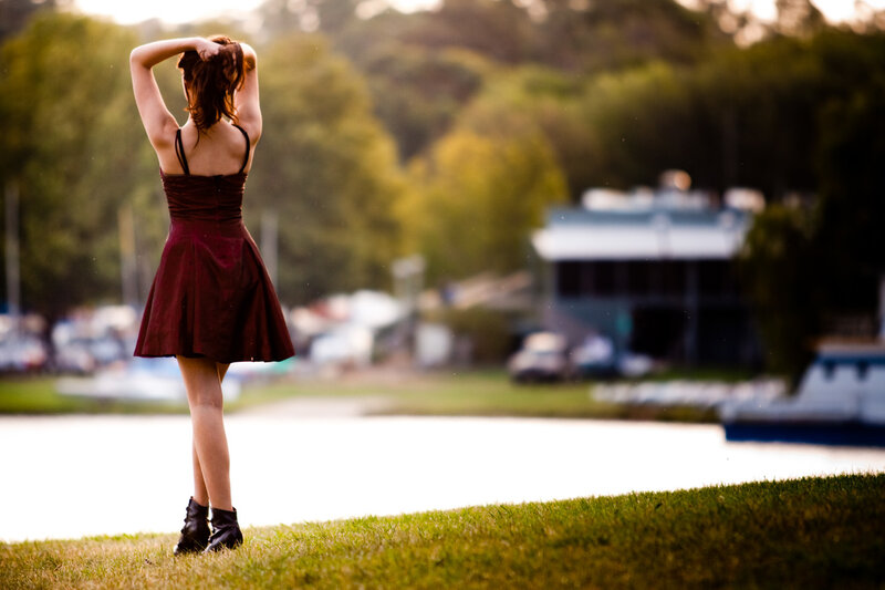 woman in red dress by the water
