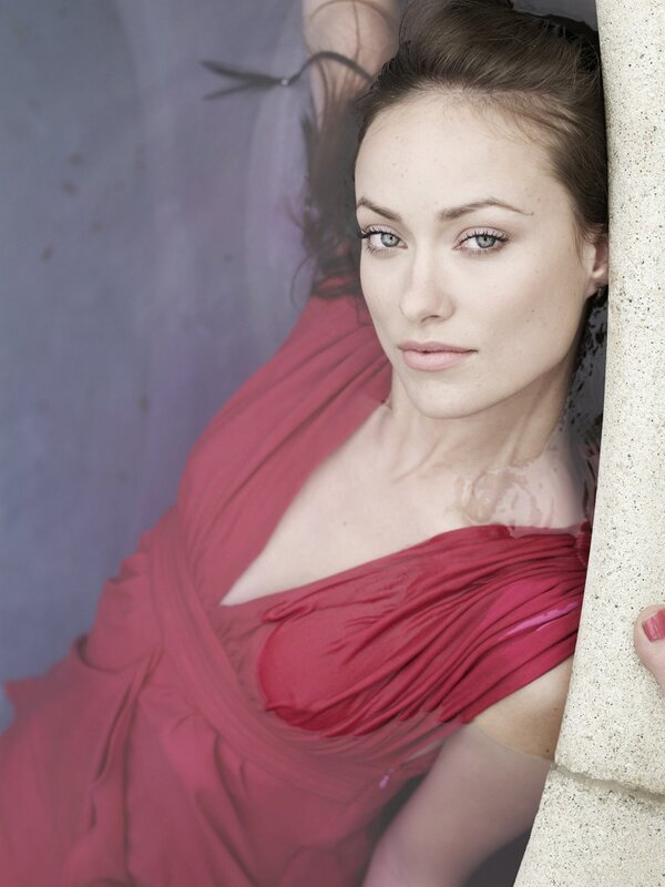 woman in red dress by wall