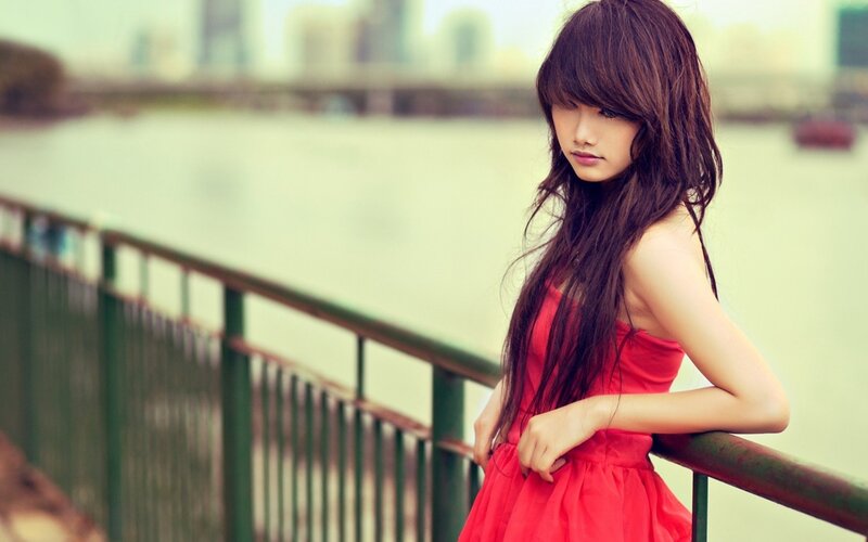 woman in red dress by water