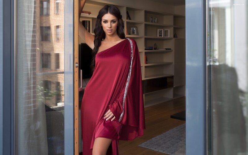 woman in red dress by window