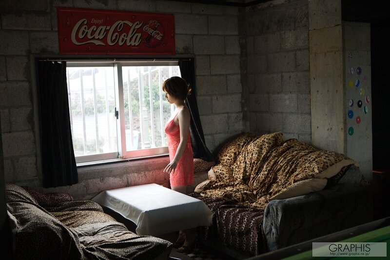 Woman in red dress by window