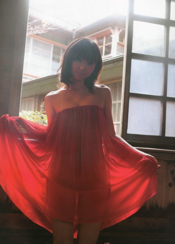 woman in red dress by window