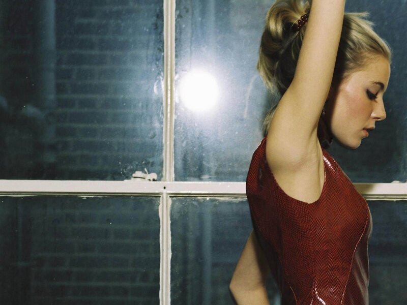 woman in red dress by window