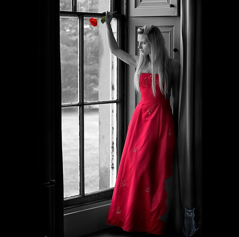 woman in red dress by window